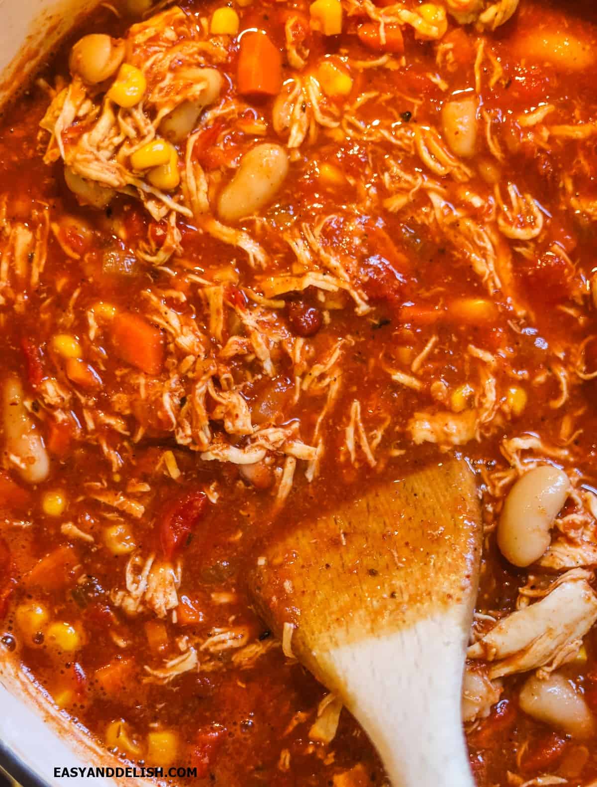 Beans and corn added to the cooking pot. 