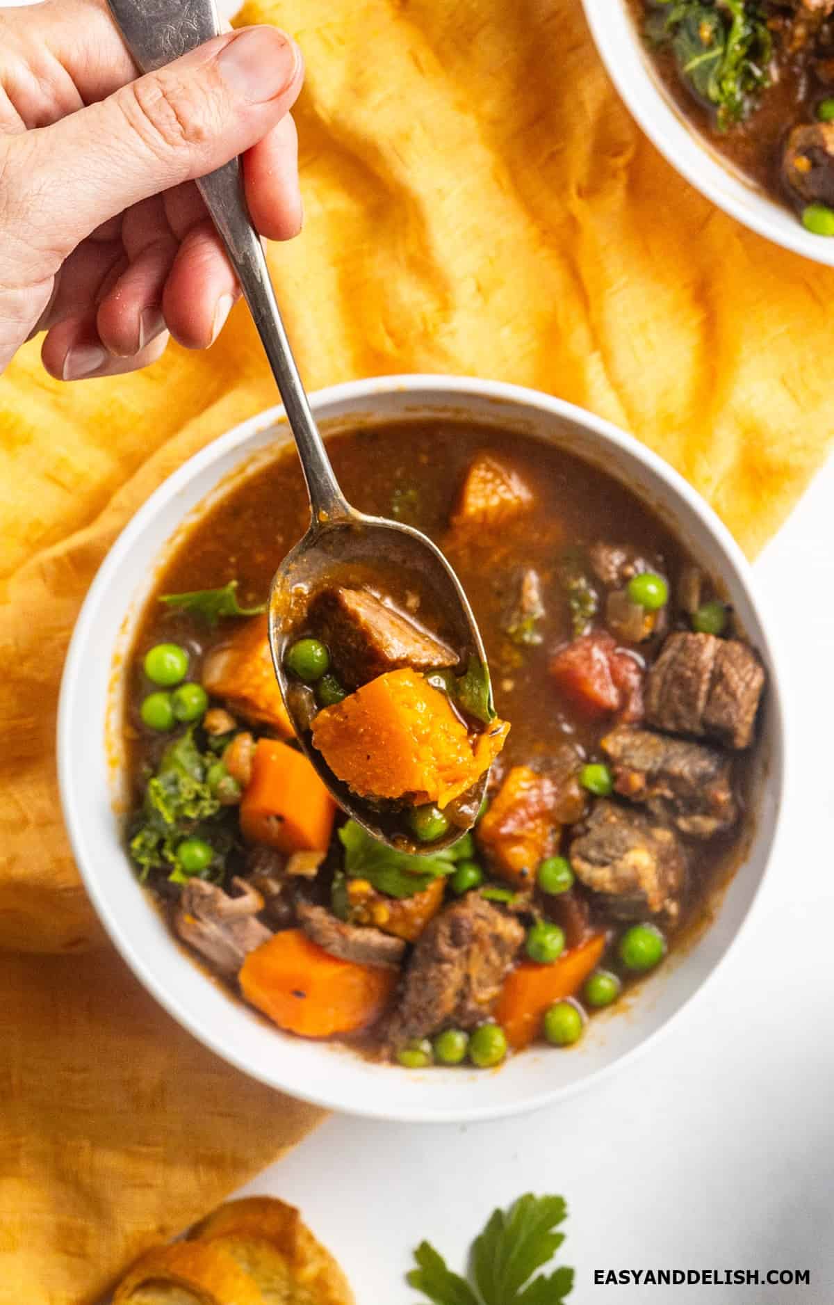 Spooning soup in a bowl. 