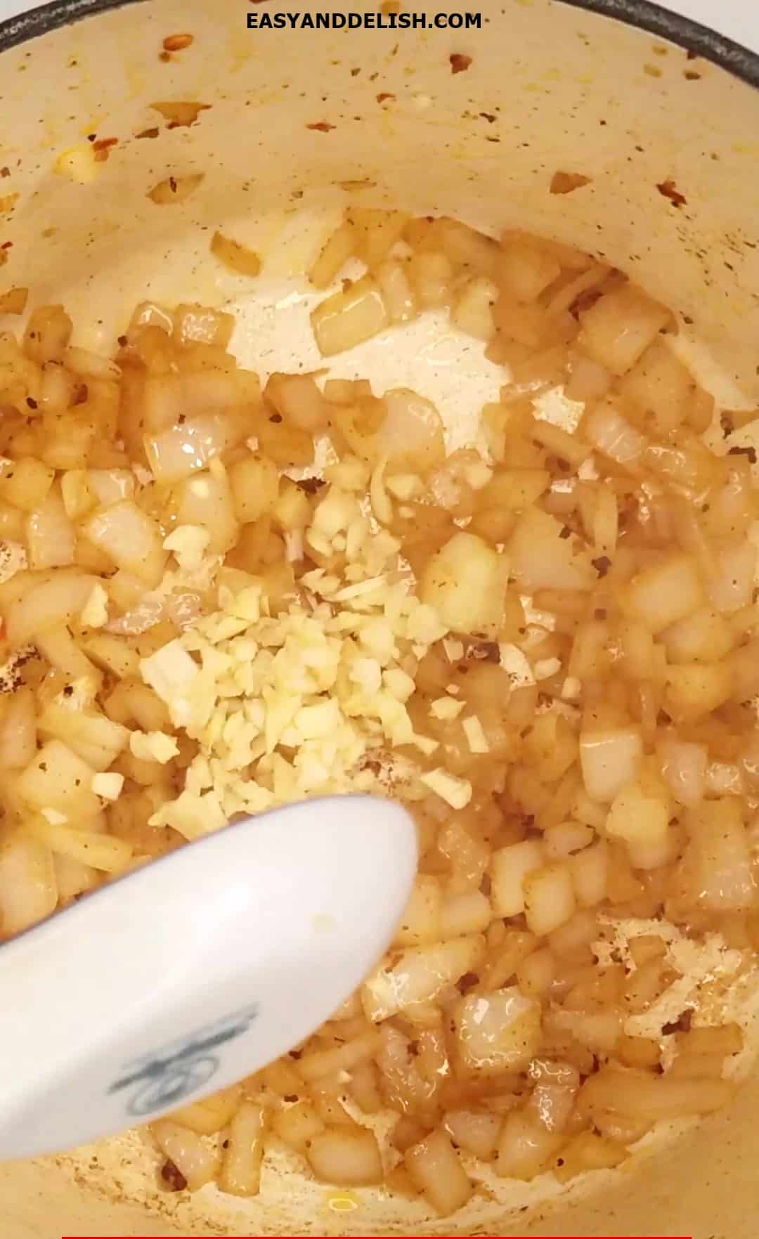 Onion and garlic sauteed in a pot. 