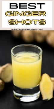 Close up of a glass of best ginger shots with ginger root around it.