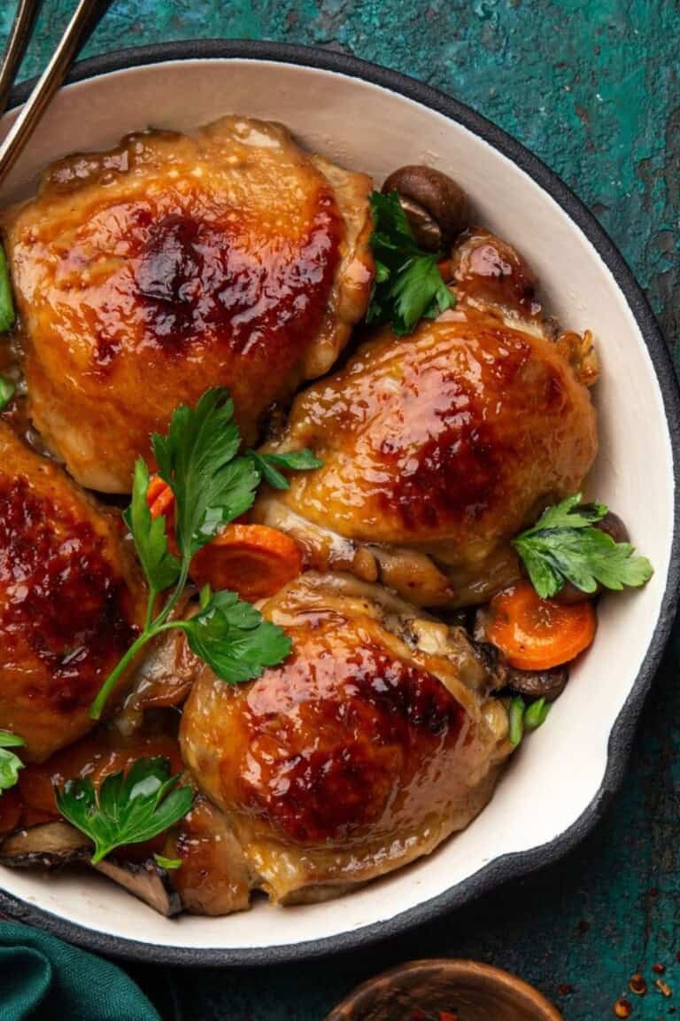 Honey mustard chicken with vegetables in a baking pan.