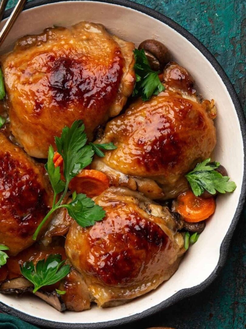Honey mustard chicken with vegetables in a baking pan.