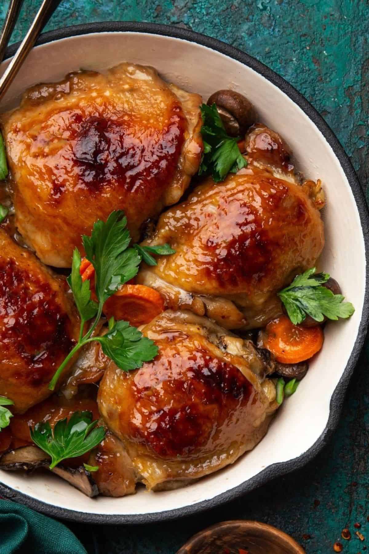 Honey mustard chicken with vegetables in a baking pan.