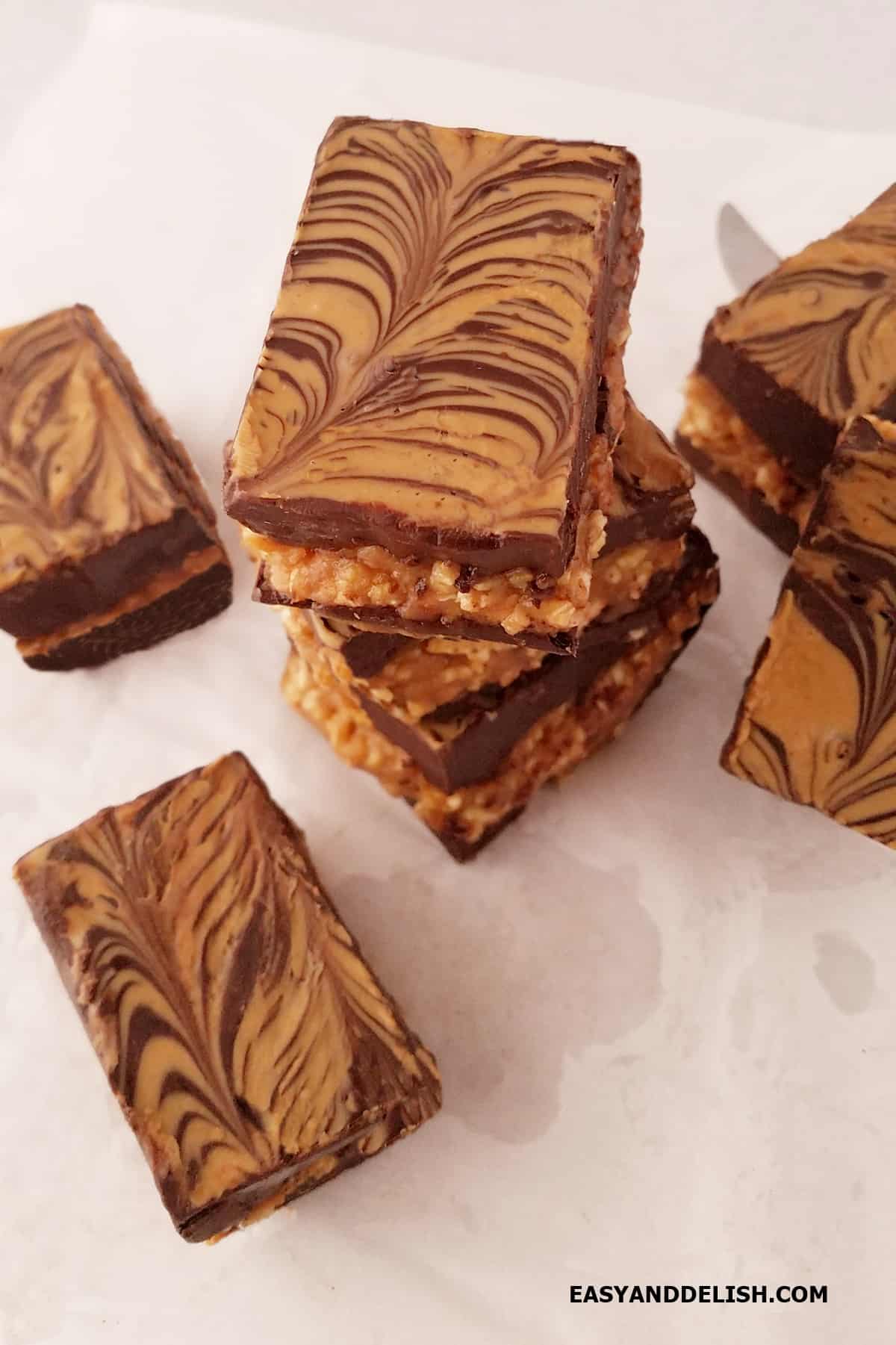 A pile of peanut butter chocolate crunch bars on a table. 