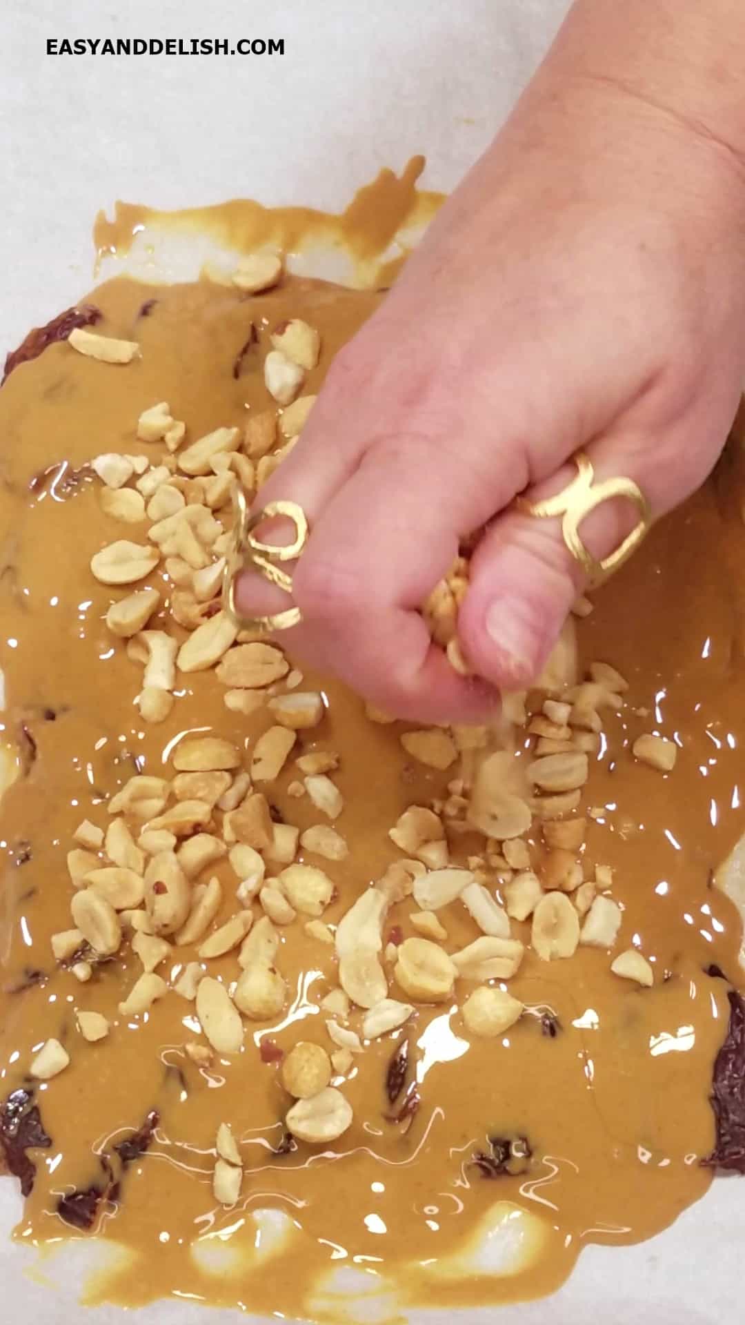Chopped peanuts placed on top of a layer of peanut butter. 