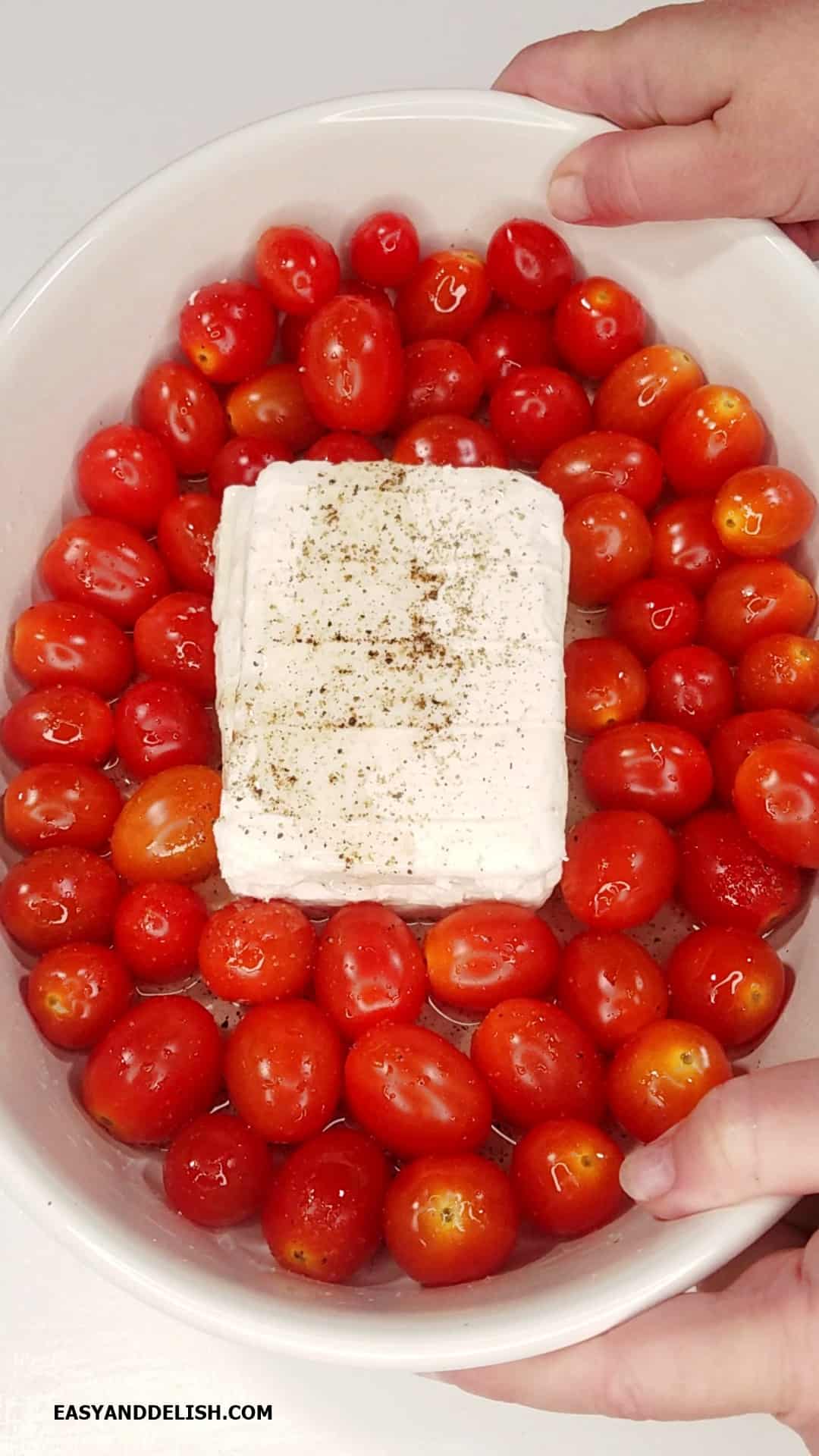 feta and cherry tomatoes in a baking dish.