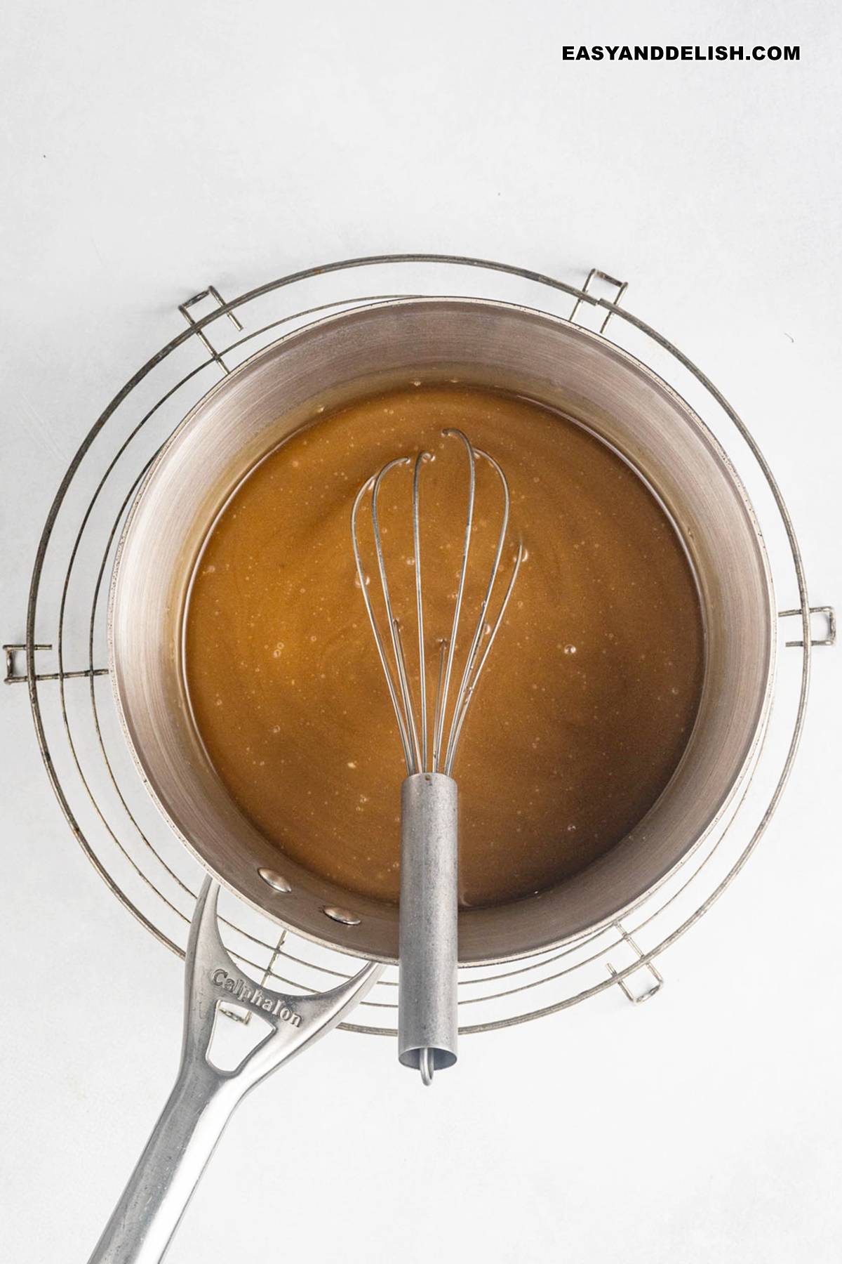 sauce mixture whisked in a saucepan.