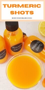 Close up of turmeric shots in shot bottles and in a shot glass.