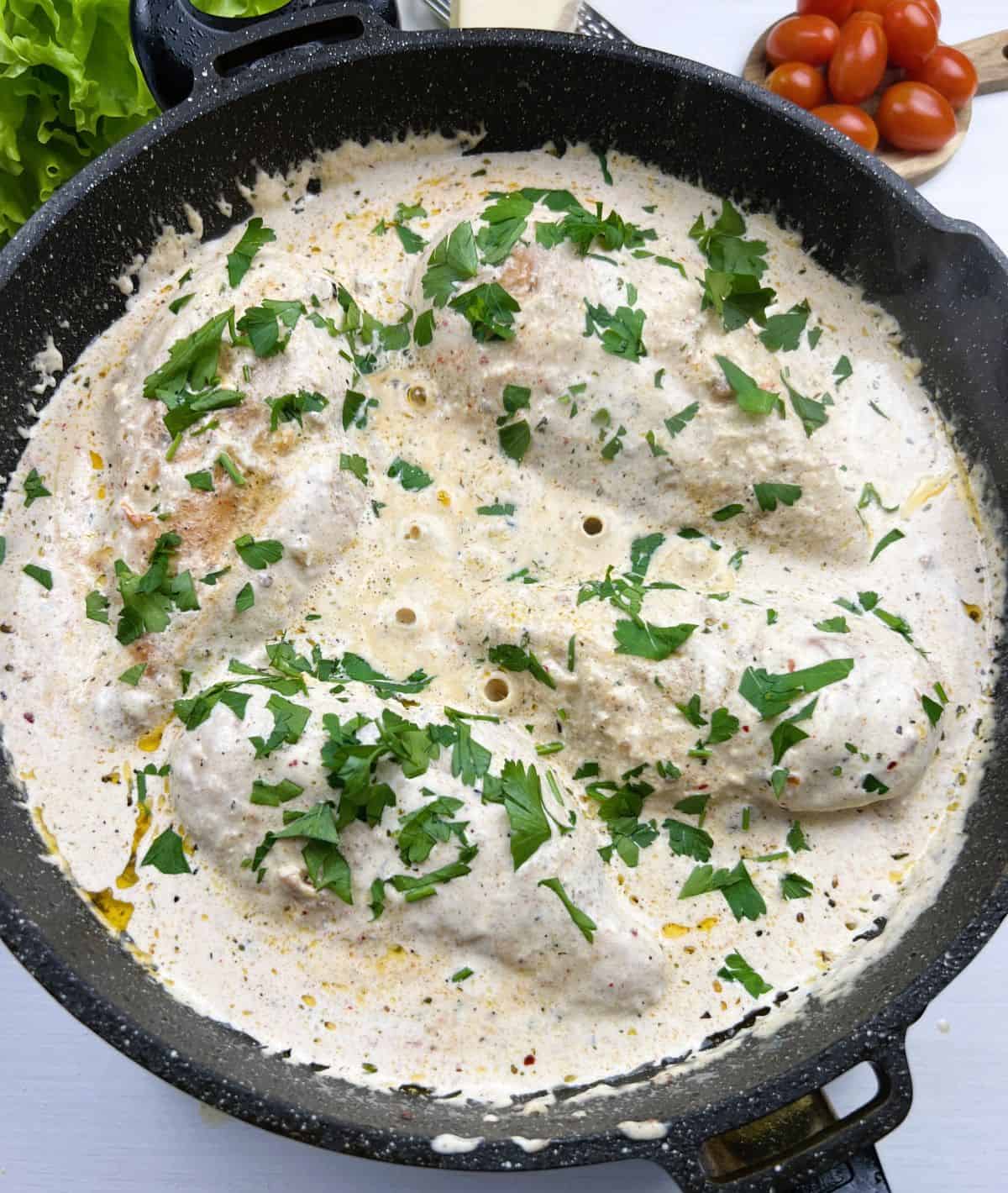 Marry Me Chicken cooking in the skillet on it's final stage.Finish Cooking the Chicken: Return the chicken to the skillet. Spoon the sauce over the chicken and simmer for 5–7 minutes. Add Parsley. The chicken is fully cooked when it reaches an internal temperature of 165°F (74°C).