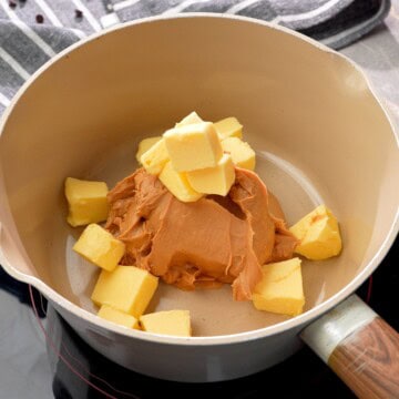 Adding butter to the saucepan with the peanut butter.