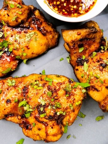 These crispy oven baked hot honey chicken thighs are sweet, spicy, crispy, and full of bold flavor.