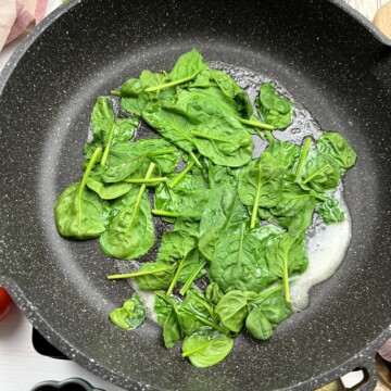 Spinach cooking in a skillet