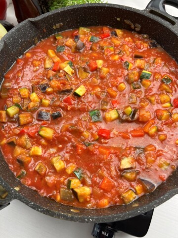 stirring shakshuka tomato base until combined