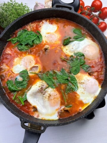 eggplant shakshuka simmering until eggs are set