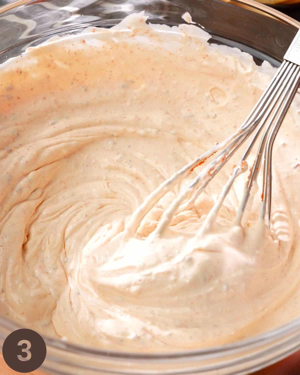 mixing taco dip base until smooth and creamy texture forms.