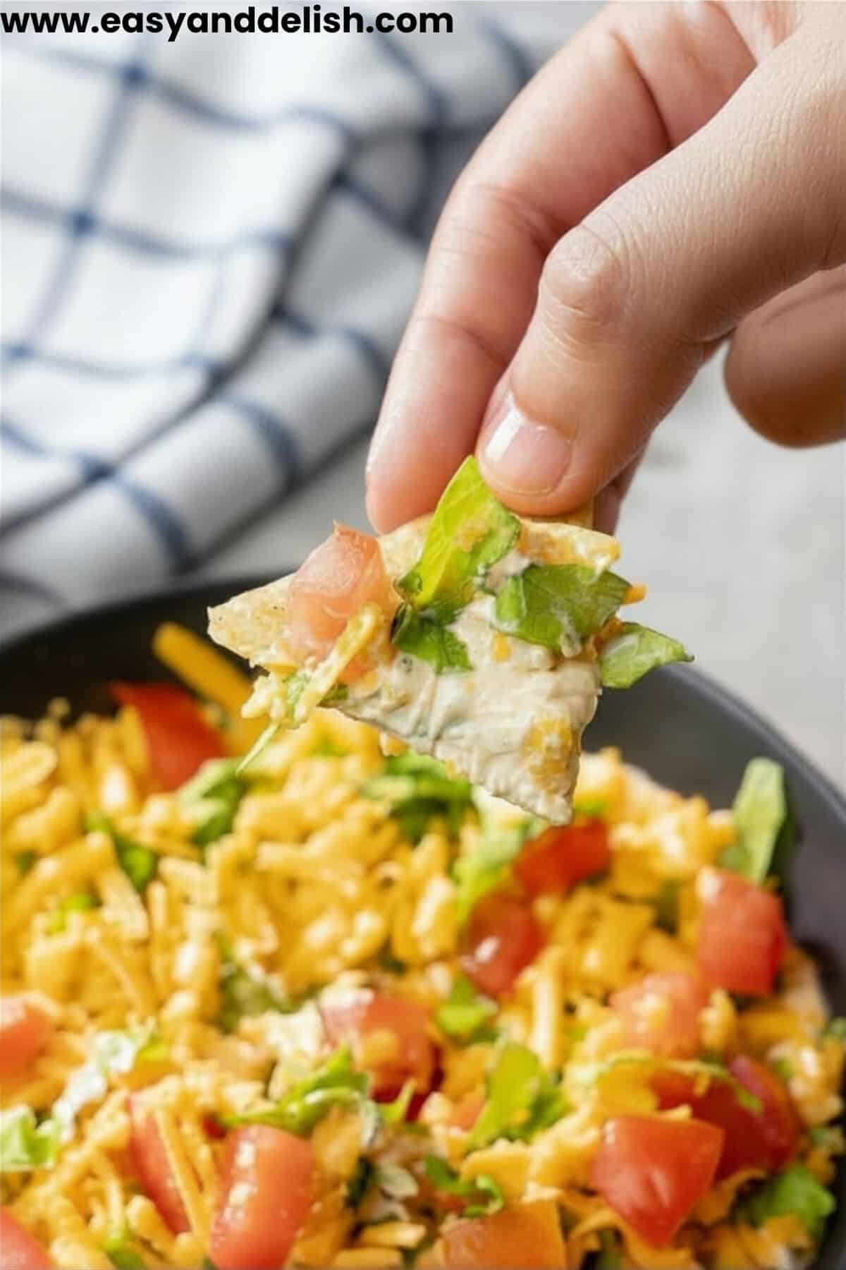 close up of easy taco dip recipe showing creamy layers and fresh toppings.