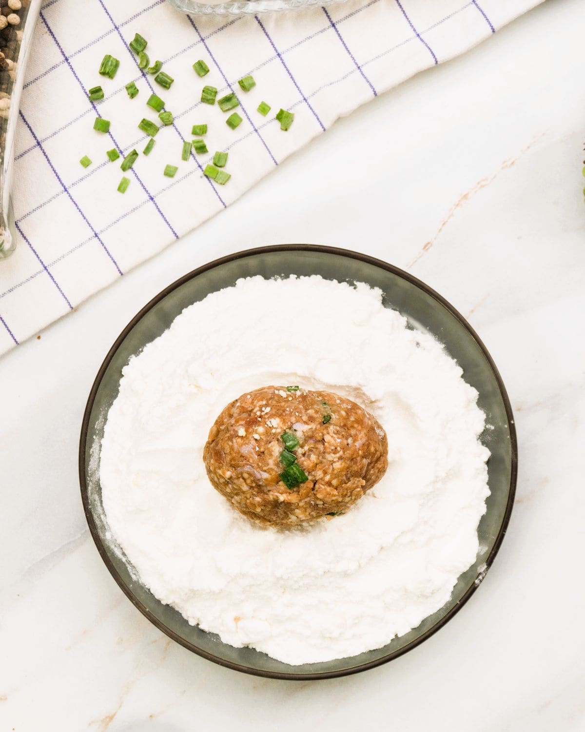 each beef-covered egg coated lightly in flour.