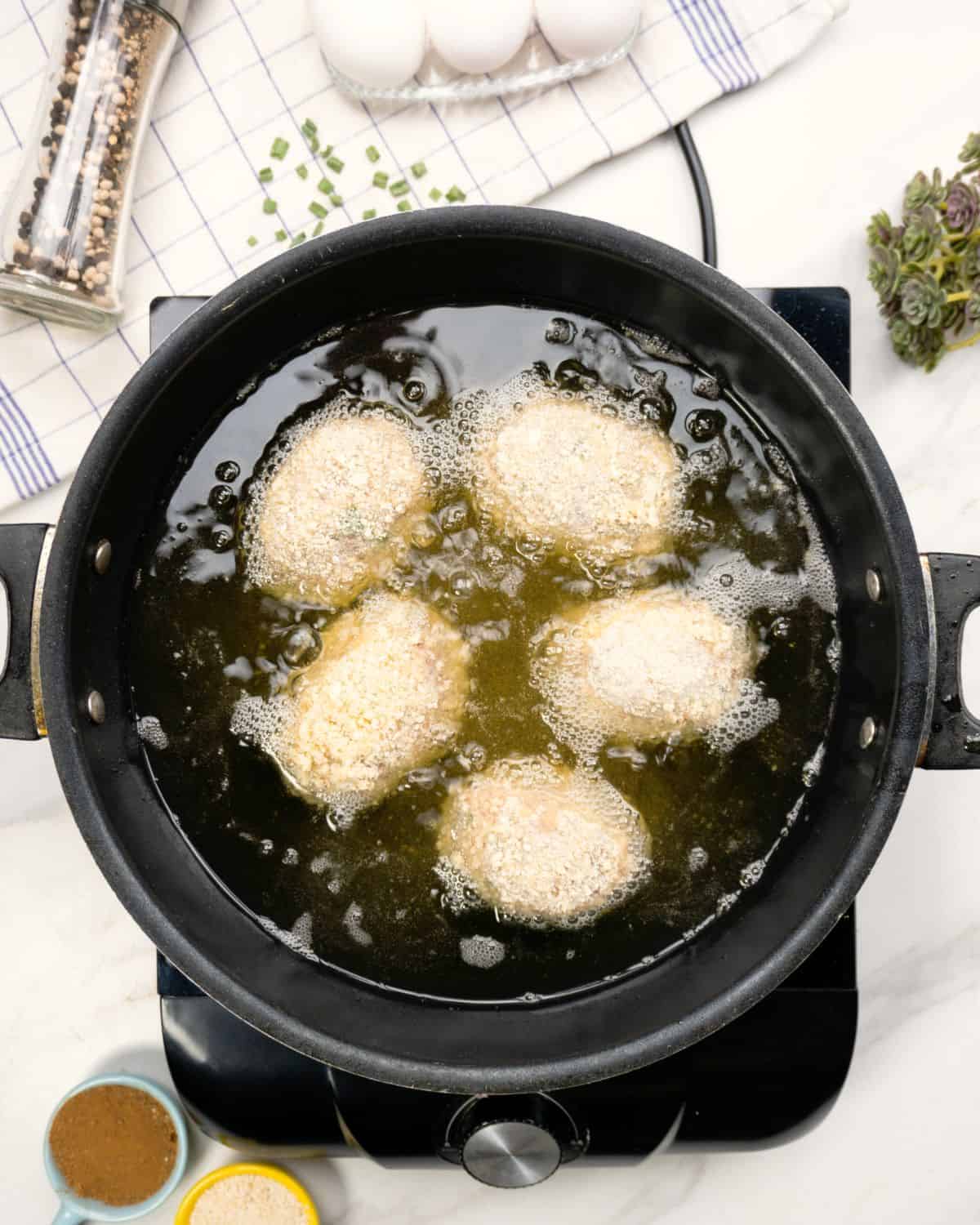 frying the Scotch eggs.