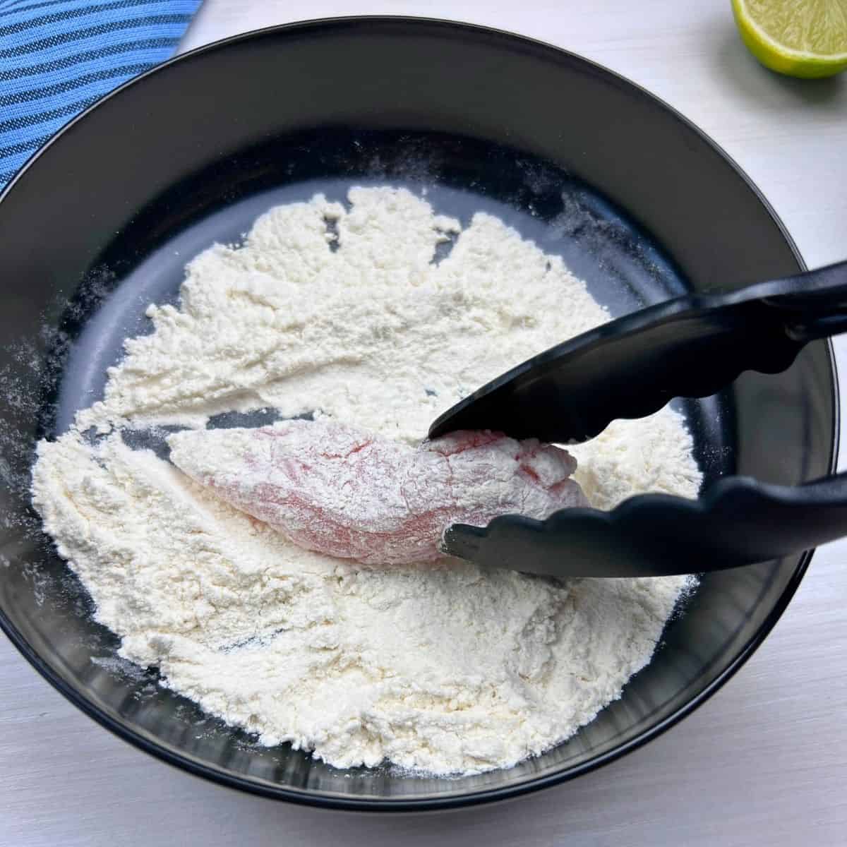Floured chicken strips for crispy lettuce wraps.