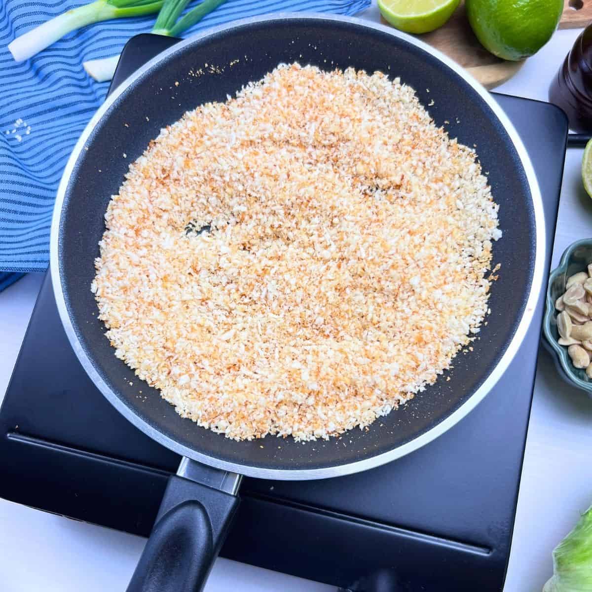 Toasting panko mixture for szechuan chicken lettuce wraps.