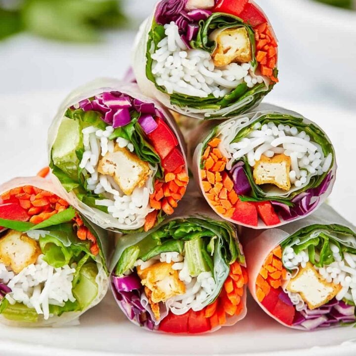 Vegetarian lunch wraps stacked on a platter.